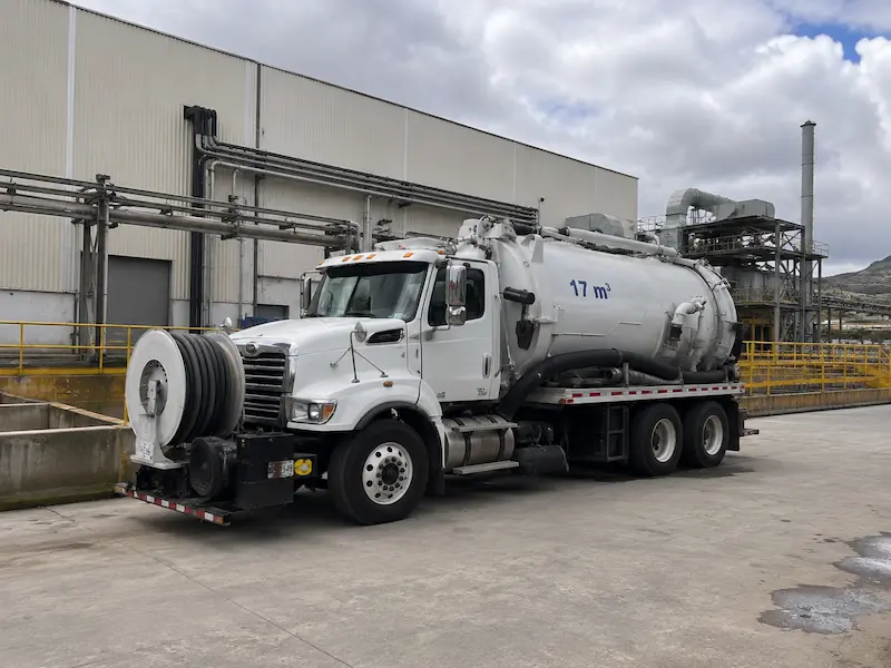 Camión vactor de 17 m3 estacionado en el patio de maniobras de una nave industrial